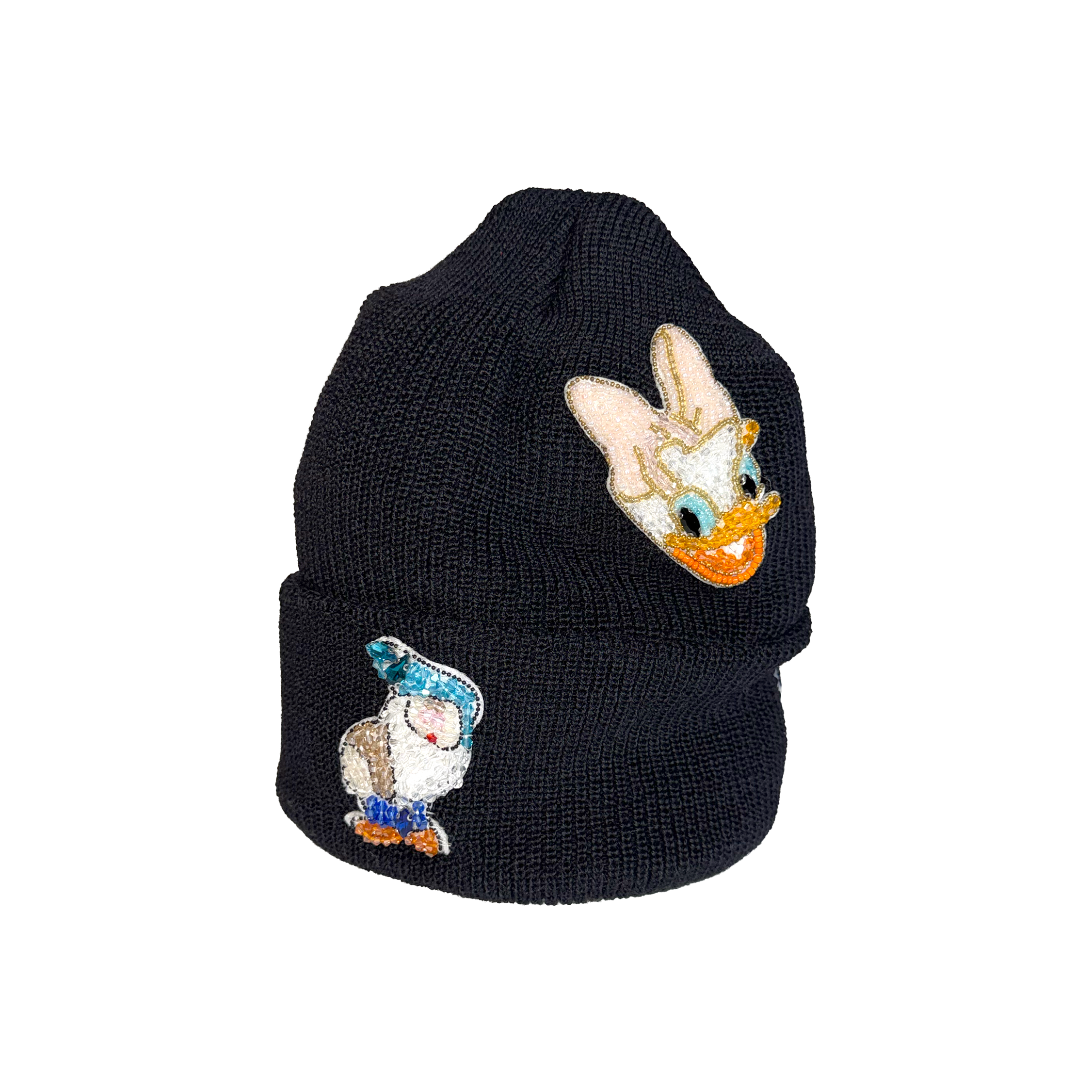 Black knit beanie with cartoon character patches on a white background.