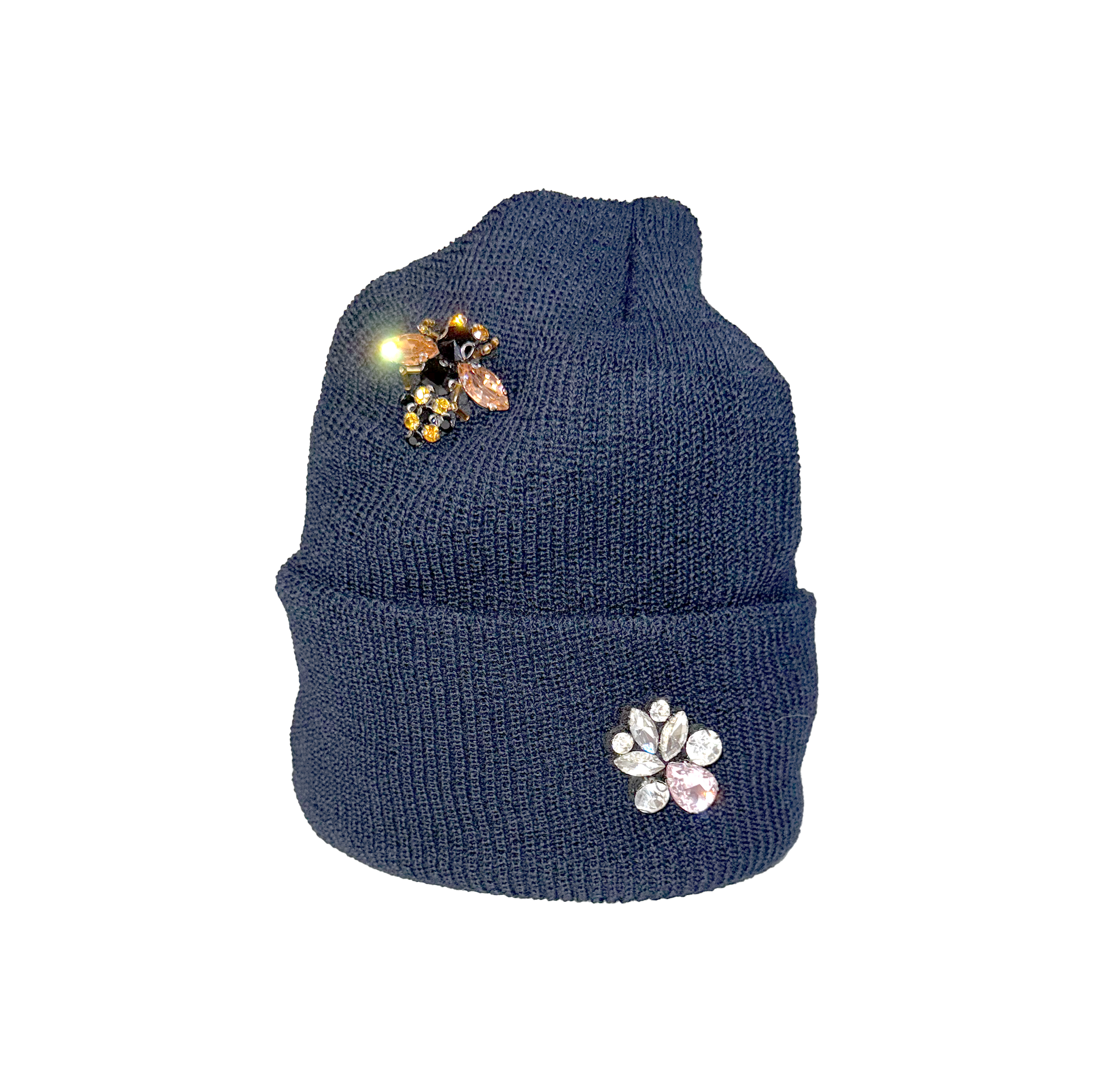 Blue knit beanie with decorative bee and flower pins on a white background