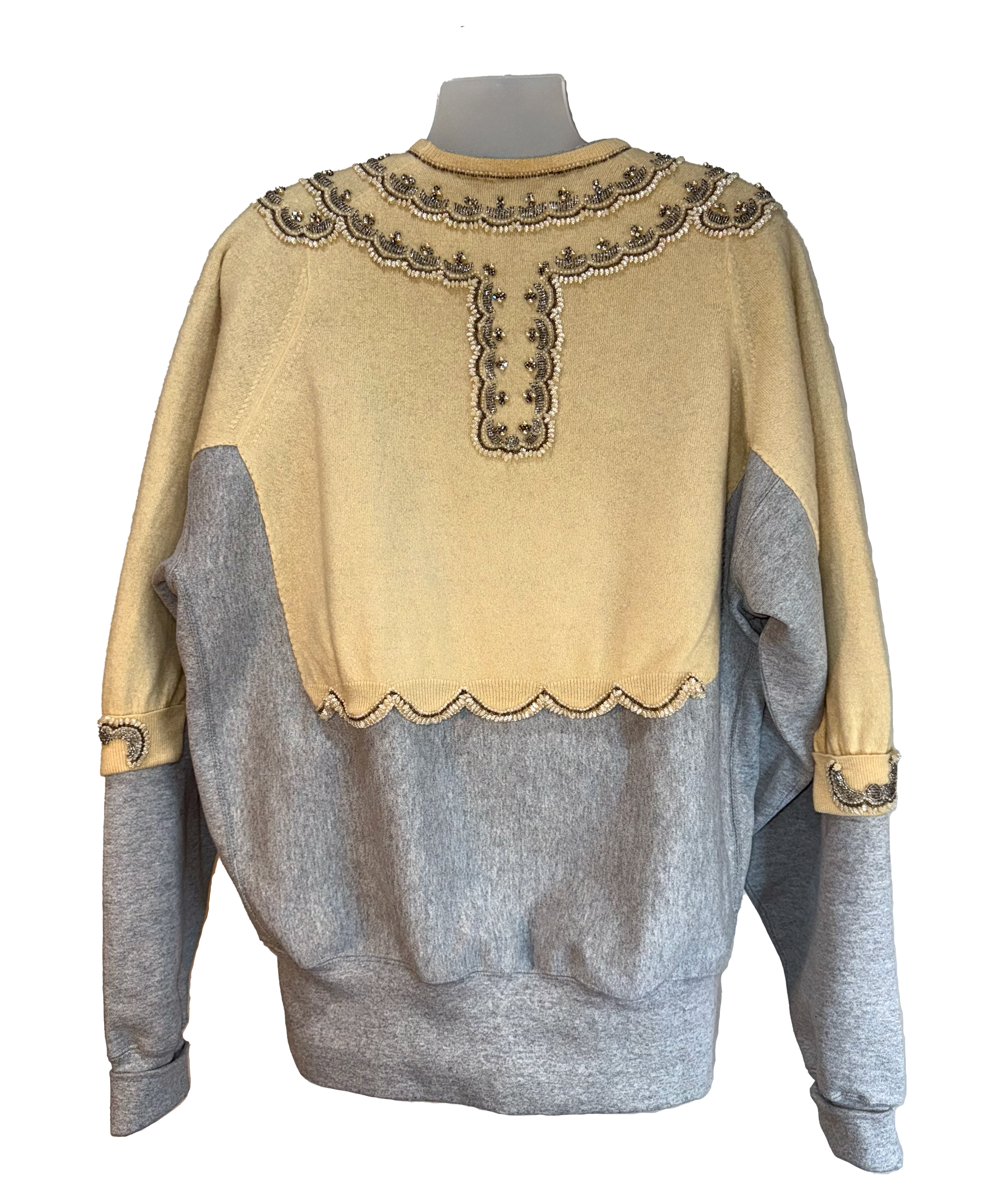 Two-tone sweater with beige top and gray sleeves on a mannequin against a white background