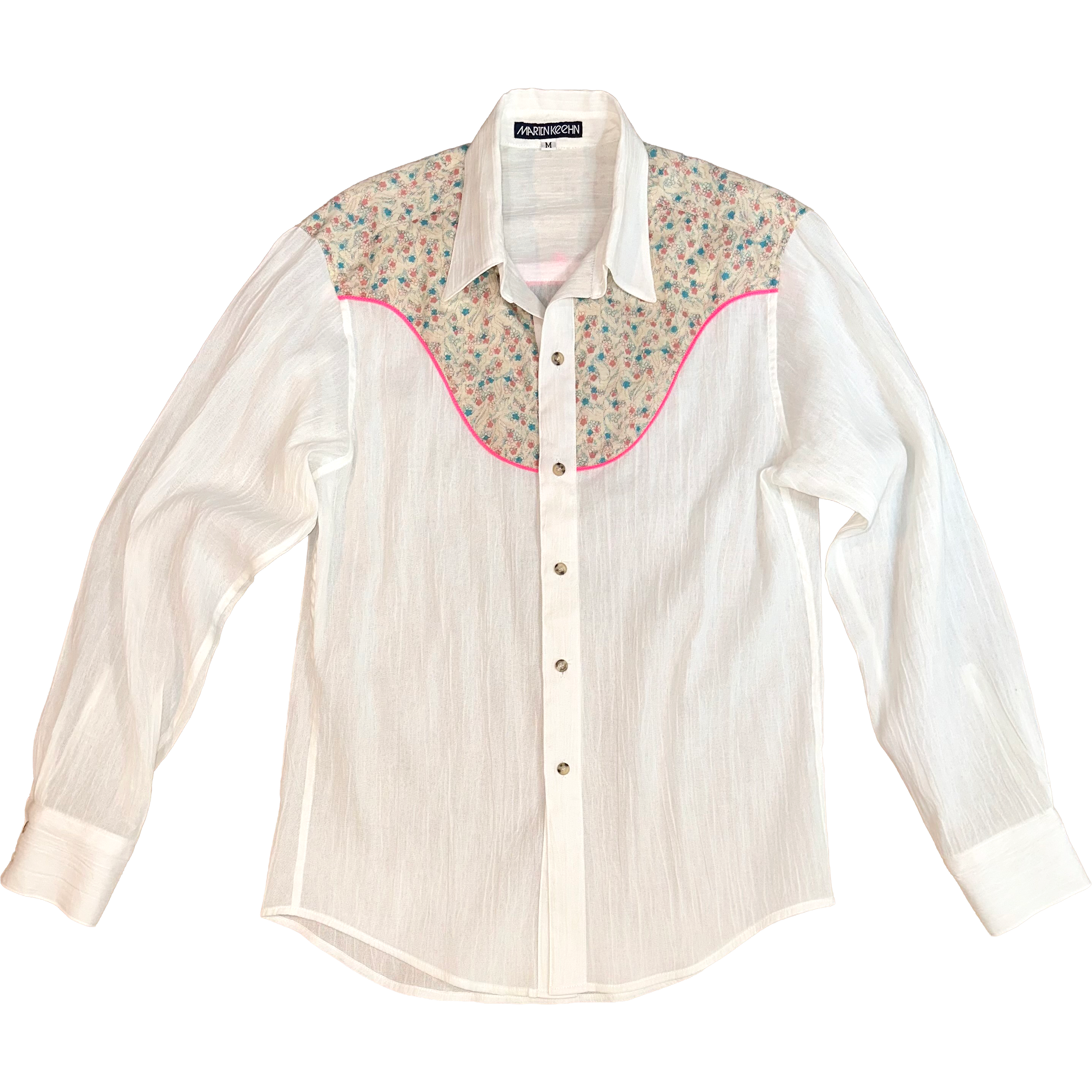 White shirt with floral and geometric patterned accents on a white background.