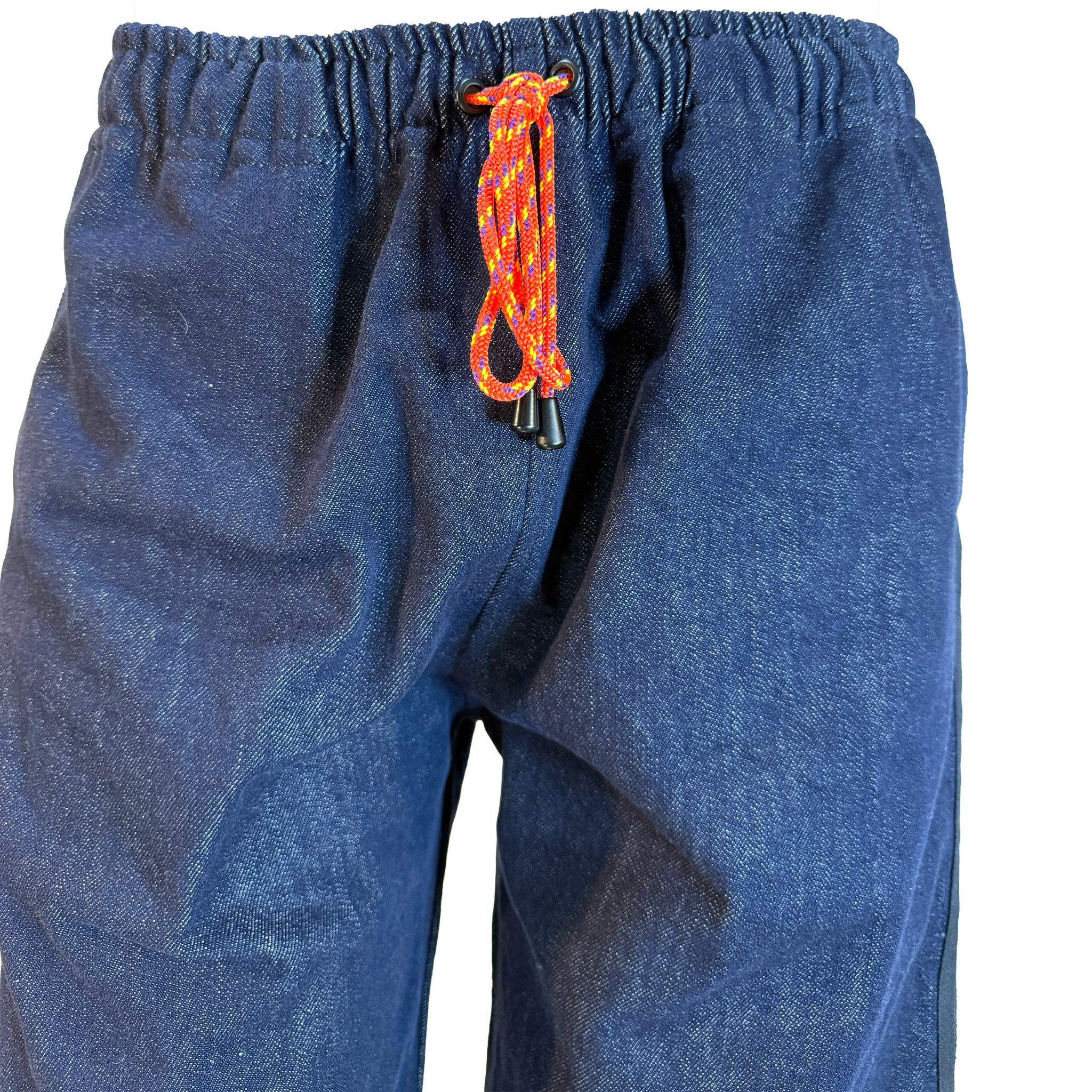 Close-up of a pair of blue denim pants with an orange and red patterned drawstring cord, shown against a plain white background.