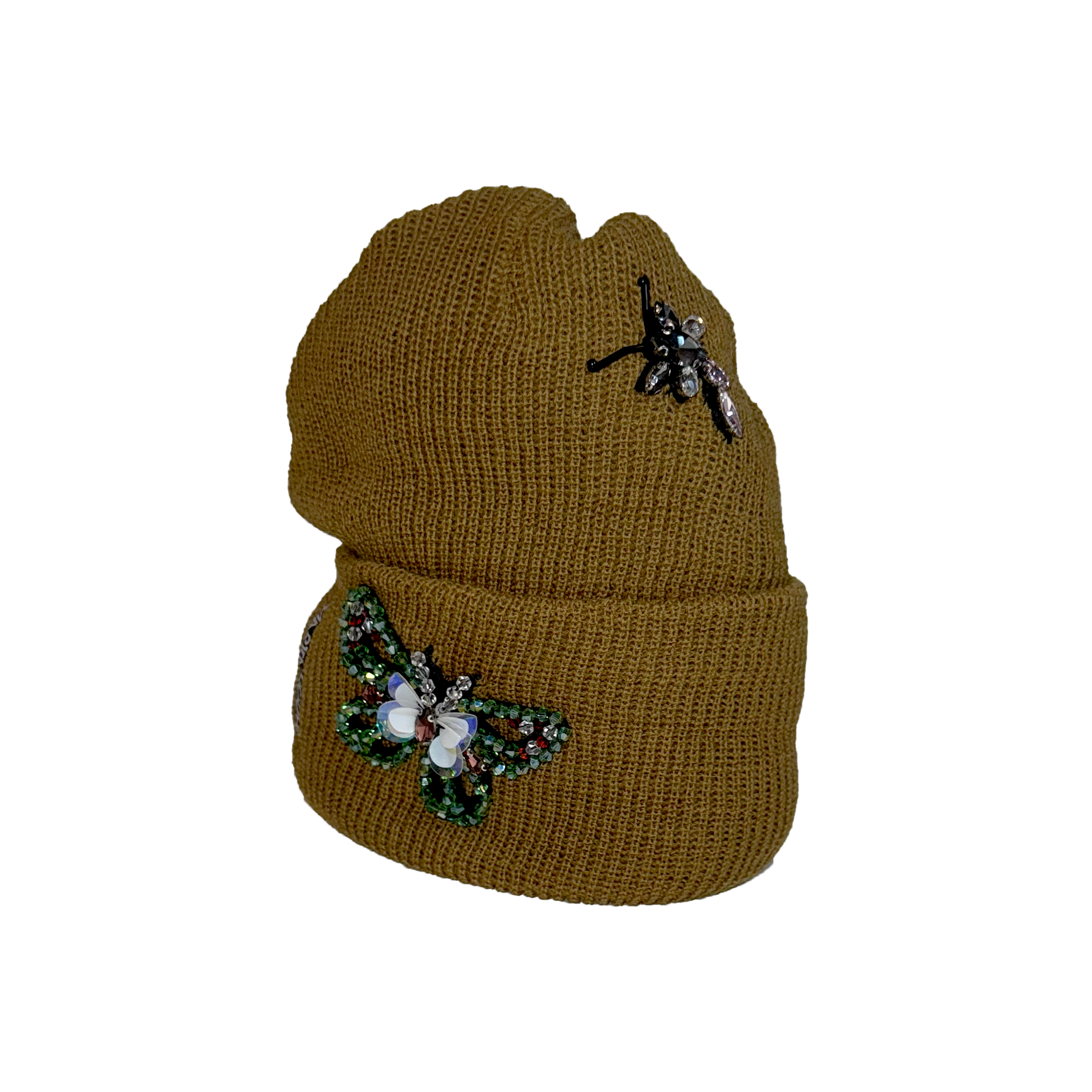 Brown knit beanie with decorative elements on a white background.