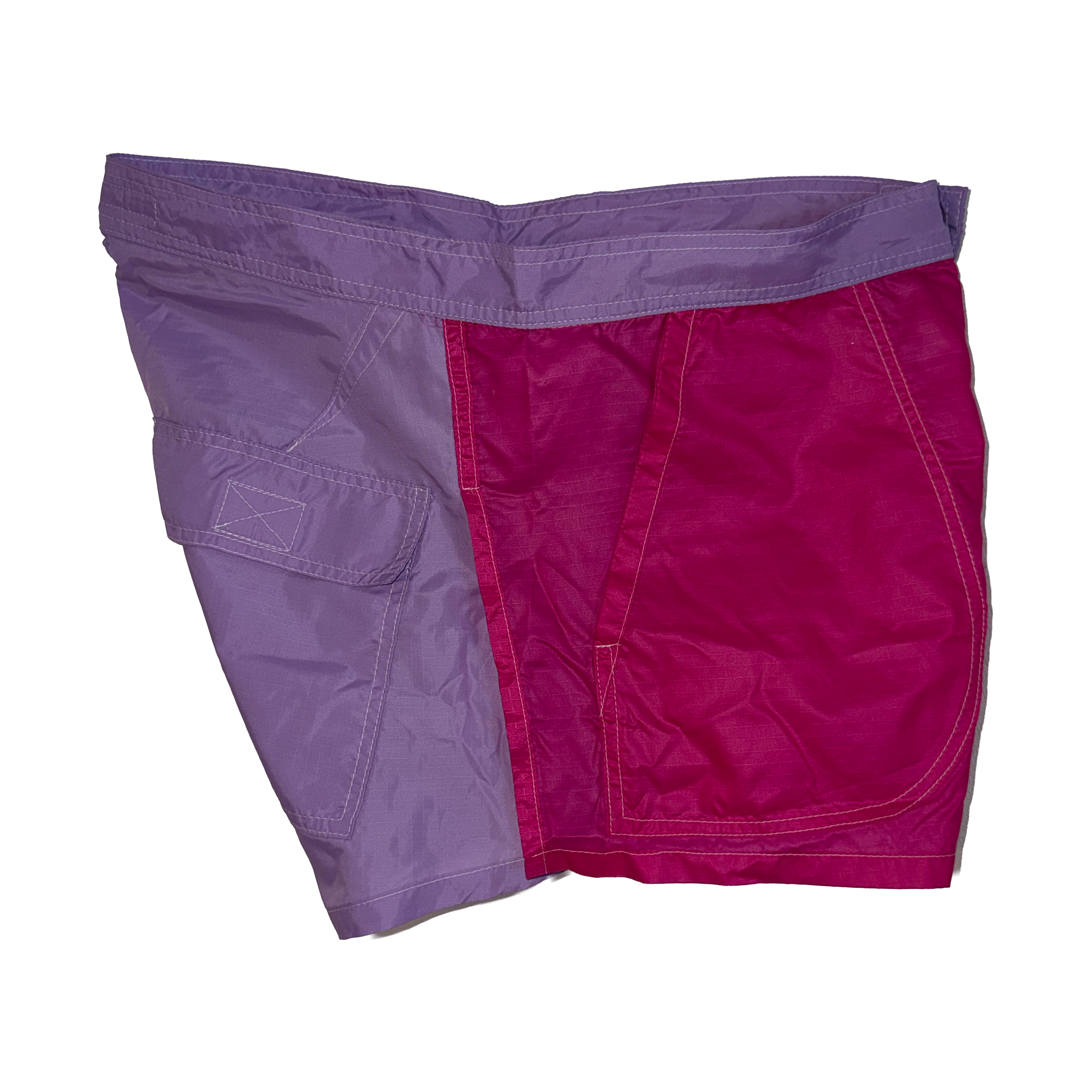 A pair of shorts featuring a split color-blocked design with one side in lavender purple and the other side in magenta pink, shown flat on a white background.