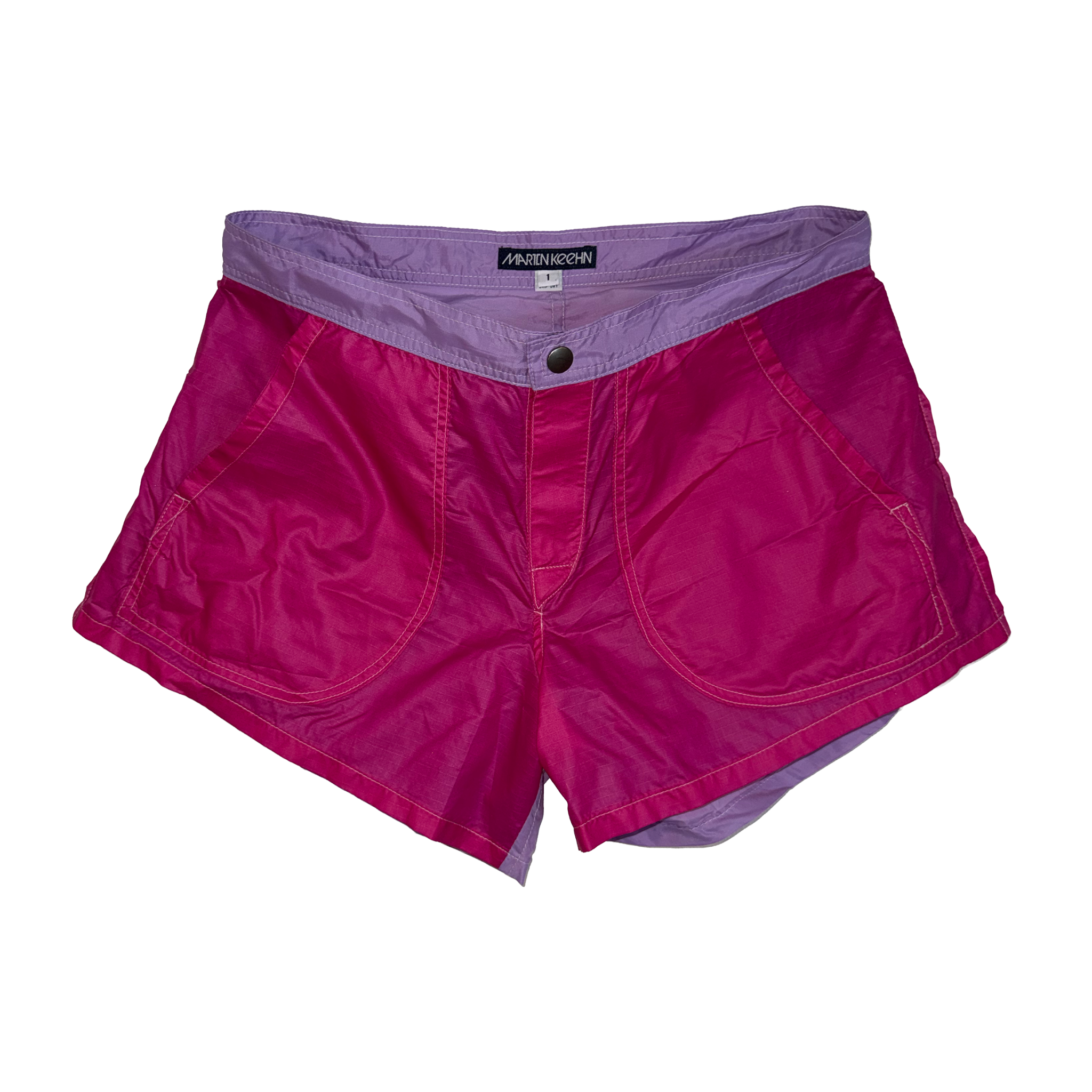 A pair of men's swim shorts, featuring a vibrant magenta-pink exterior and a contrasting light purple interior lining and waistband, shown flat on a white background.