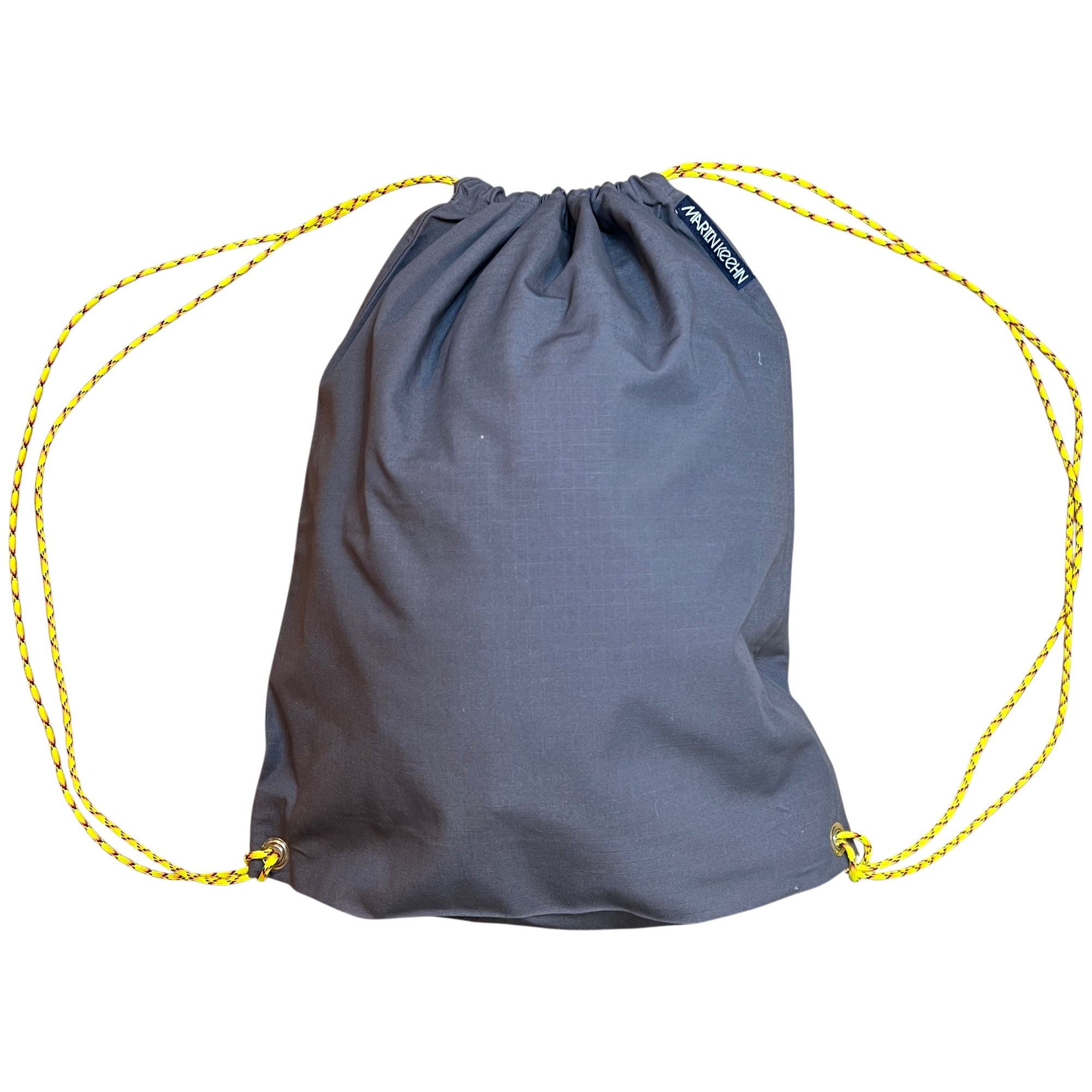 Gray drawstring bag with yellow strings on a white background.