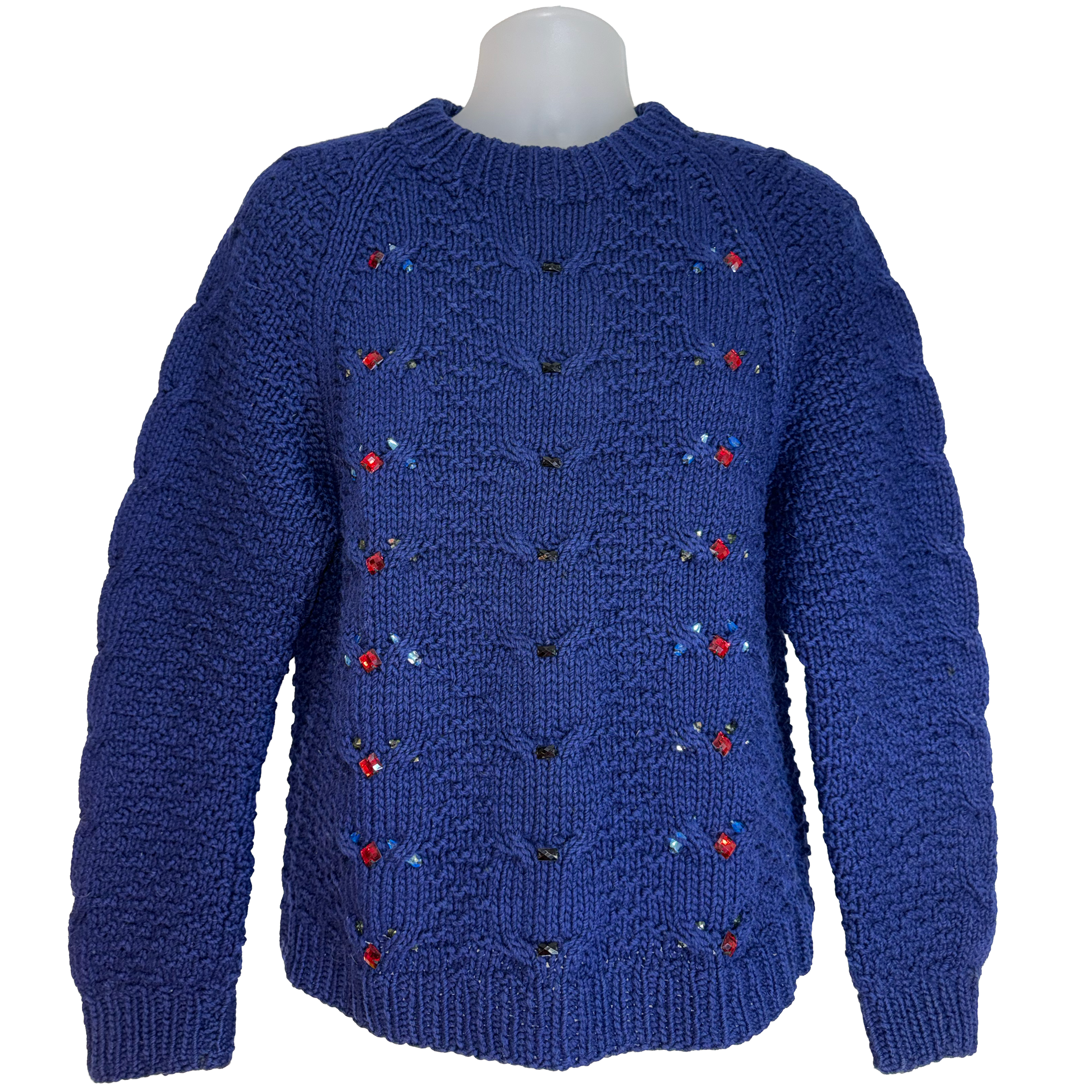A royal blue cable-knit sweater displayed on a mannequin torso against a plain white background. The sweater features small embroidered floral details in red, blue, and green along vertical rows on the chest.