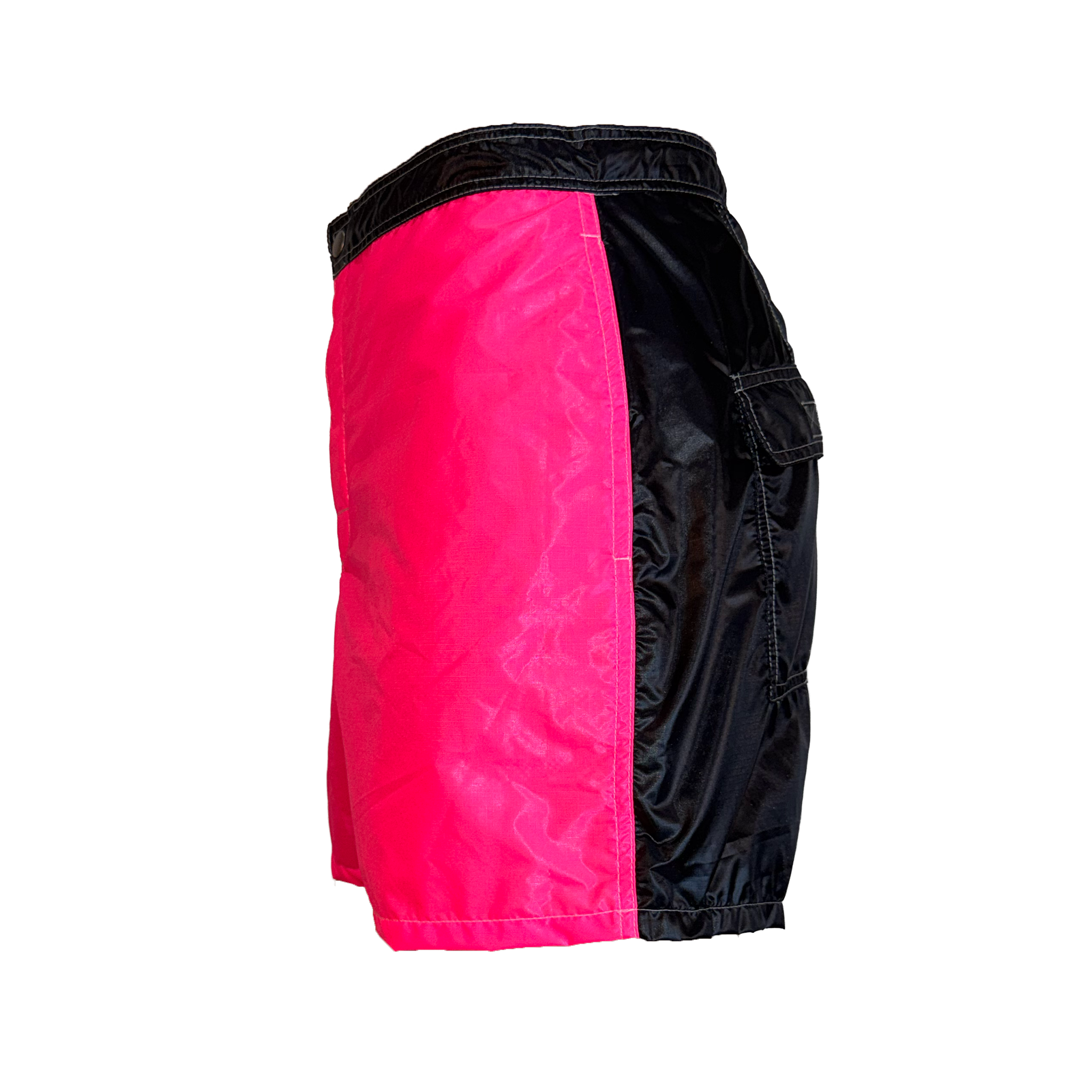 Colorblock athletic shorts with a bright pink front panel, black side panels, and a black elastic waistband, shown from a side profile view on a white background.