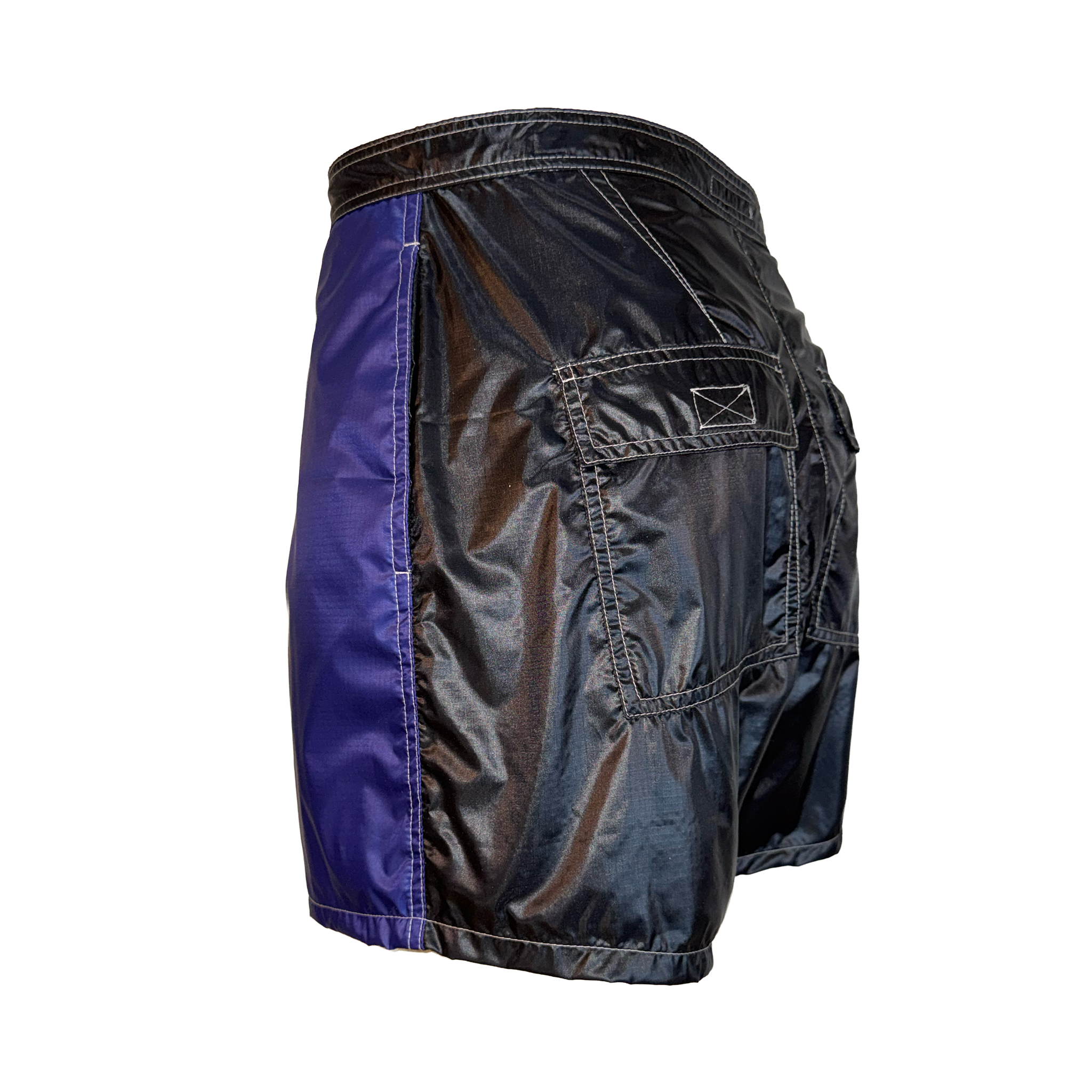 A pair of athletic shorts shown from a three-quarter back view, featuring a black metallic finish on the main body and a contrasting purple side panel.