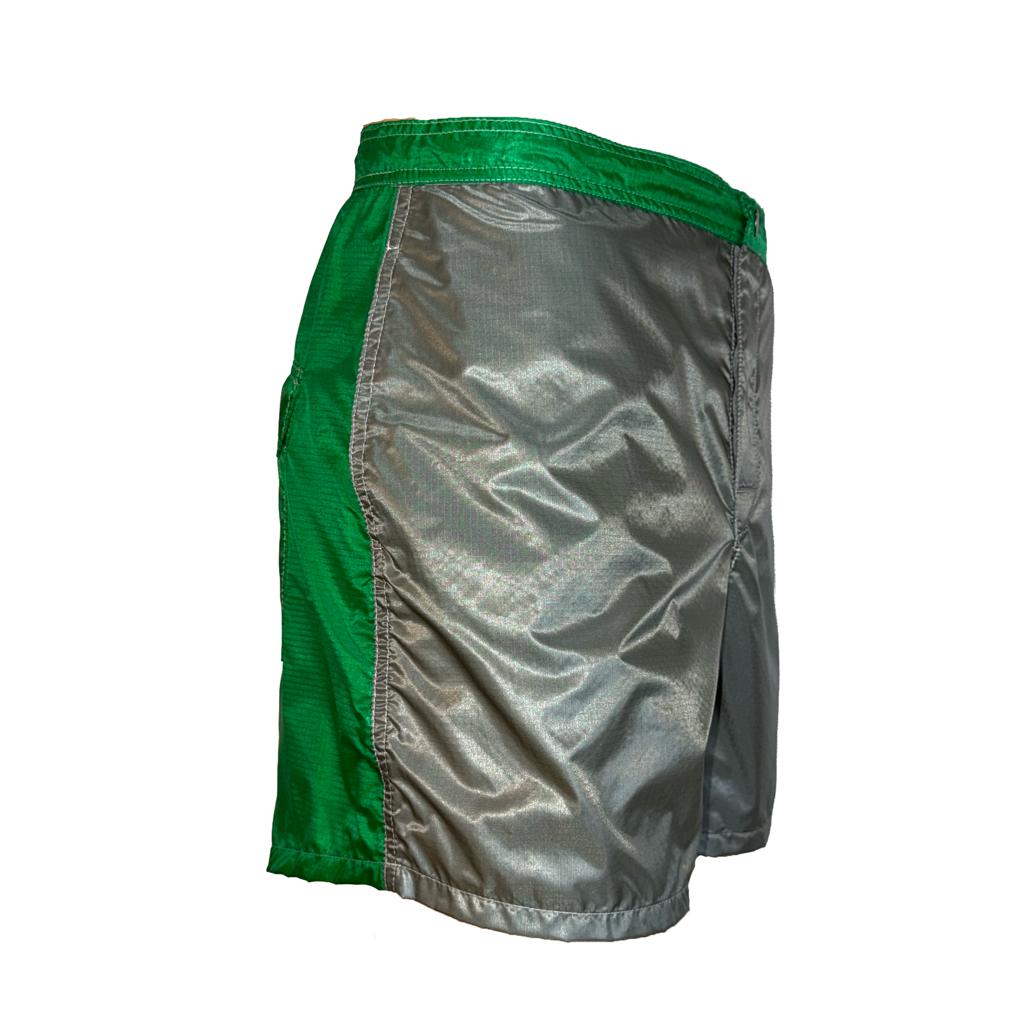 A pair of athletic shorts with a metallic silver body and bright green side panels, waistband, and top edge, shown against a plain white background.
