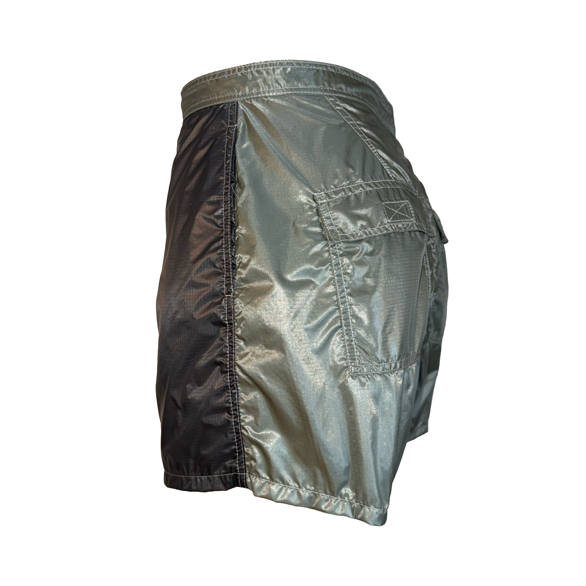 A pair of metallic silver athletic shorts with a dual-tone design, featuring a dark metallic side panel and a lighter reflective front panel with a side cargo pocket, shown against a plain white background.