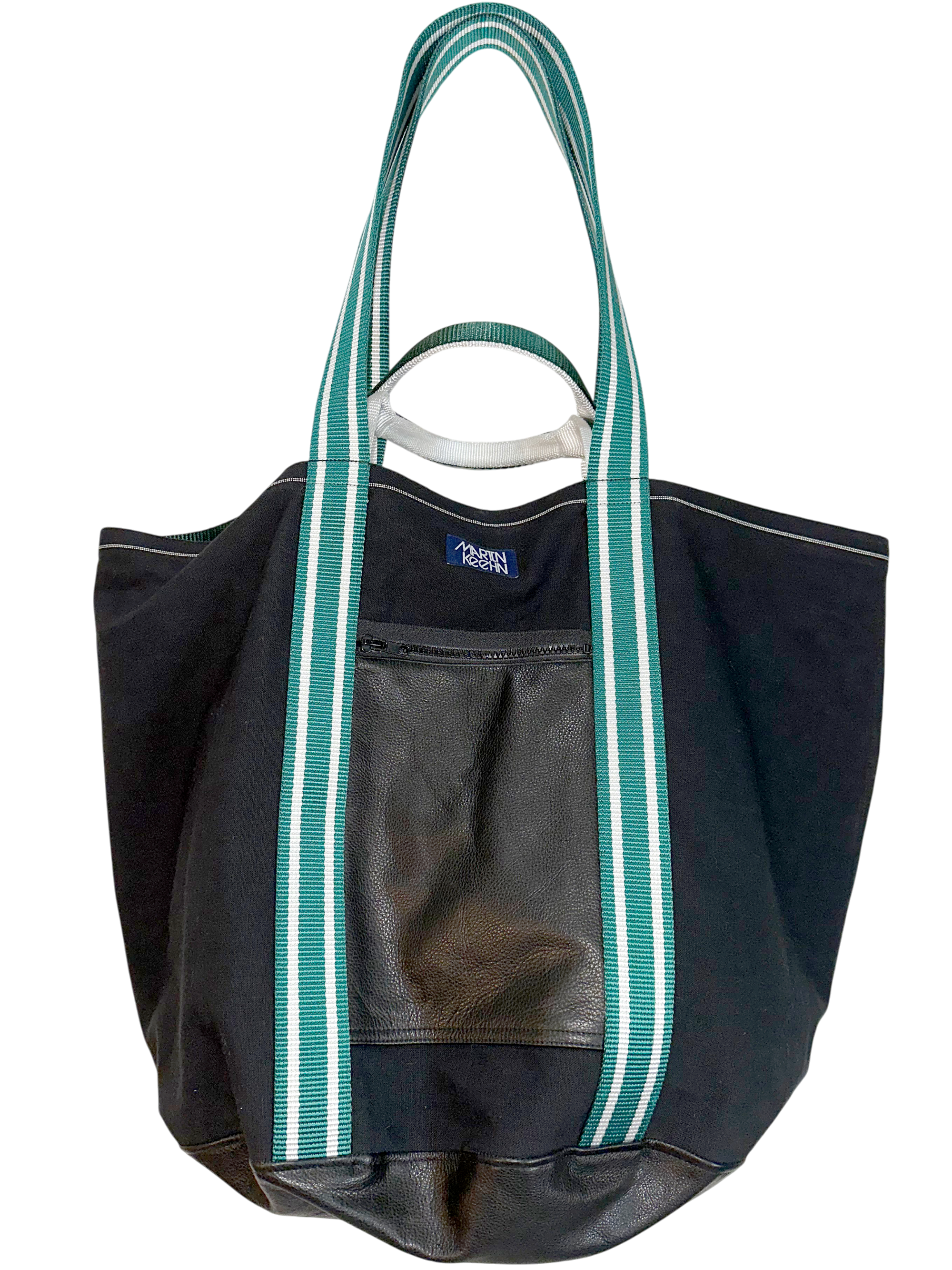 Black tote bag with green straps on a white background.