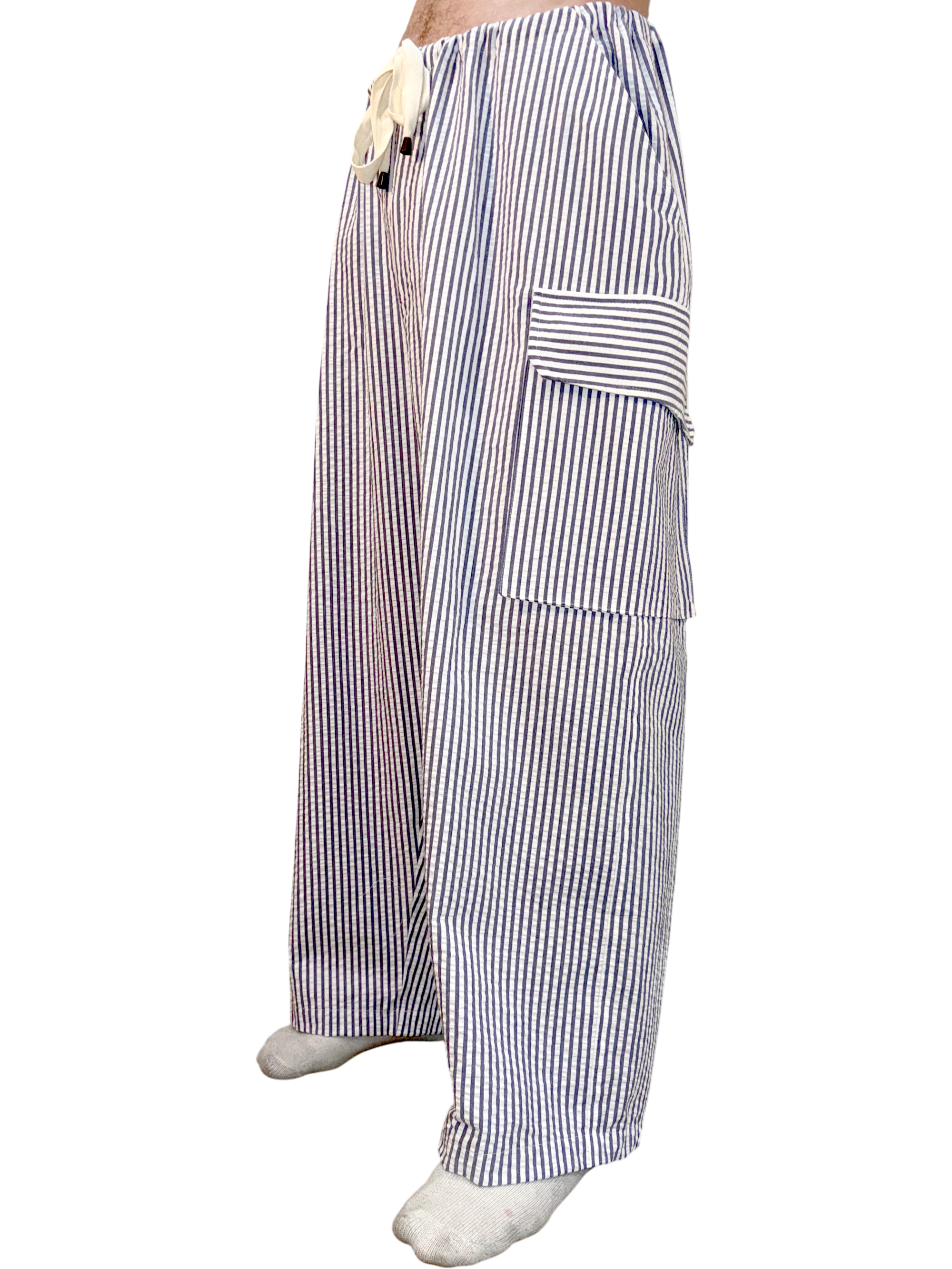 Striped pajama pants worn by a person on a white background